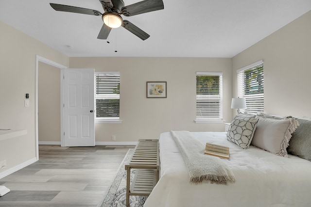 1701 SE Floresta Dr, Port Saint Lucie, FL 34983 - bedroom featuring light wood-style floors, baseboards, and a ceiling fan
