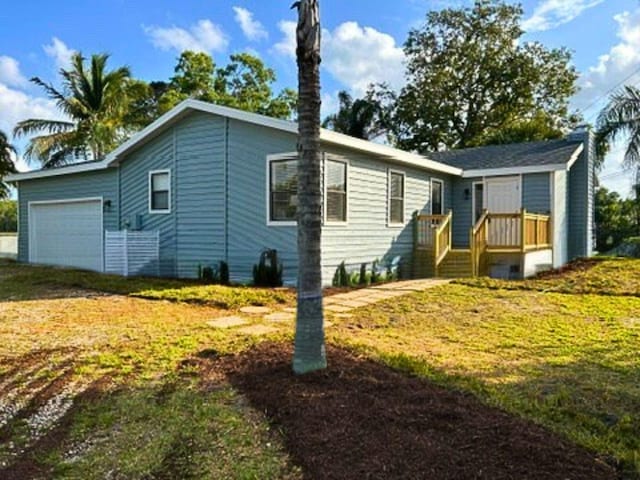 1701 SE Floresta Dr, Port Saint Lucie, FL 34983 - manufactured / mobile home with a garage and a front yard