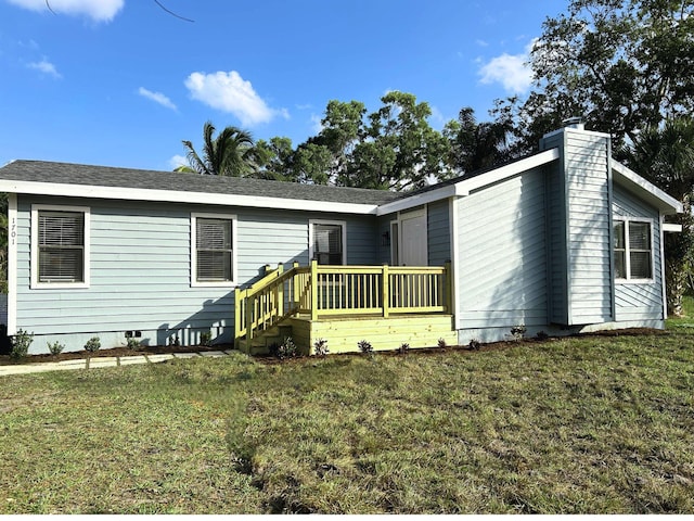 1701 SE Floresta Dr, Port Saint Lucie, FL 34983 - back of house featuring a lawn and a chimney