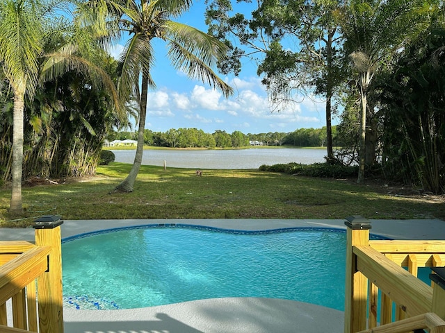1701 SE Floresta Dr, Port Saint Lucie, FL 34983 - swimming pool featuring a water view and a lawn