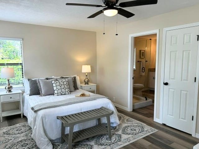 1701 SE Floresta Dr, Port Saint Lucie, FL 34983 - bedroom featuring wood finished floors, baseboards, ensuite bathroom, and a ceiling fan