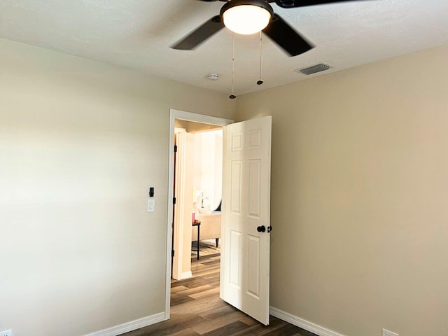 1701 SE Floresta Dr, Port Saint Lucie, FL 34983 - unfurnished bedroom featuring dark wood-style flooring, baseboards, and ceiling fan