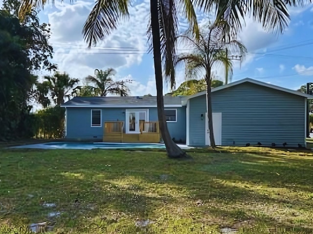 1701 SE Floresta Dr, Port Saint Lucie, FL 34983 - back of property featuring a yard and a deck