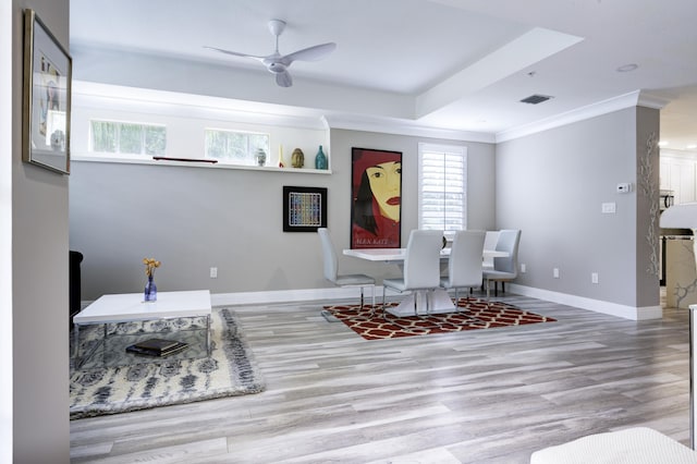 living area featuring ceiling fan, wood finished floors, baseboards, and ornamental molding
