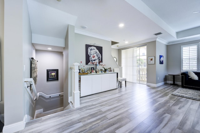 welcome area with crown molding and recessed lighting