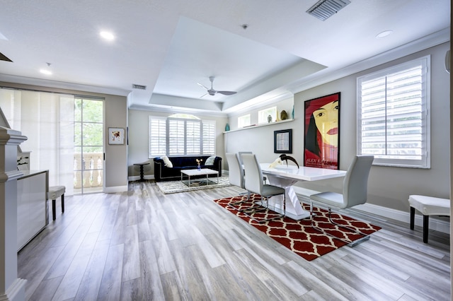 dining area featuring a raised ceiling, baseboards, wood finished floors, and recessed lighting