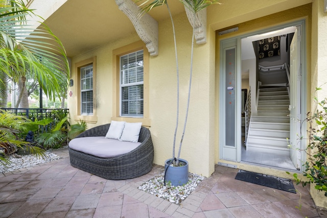view of exterior entry featuring stucco siding