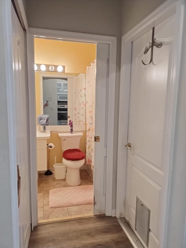 1047 NW Tuscany Dr, Port Saint Lucie, FL 34986 - bathroom with toilet, vanity, and wood finished floors