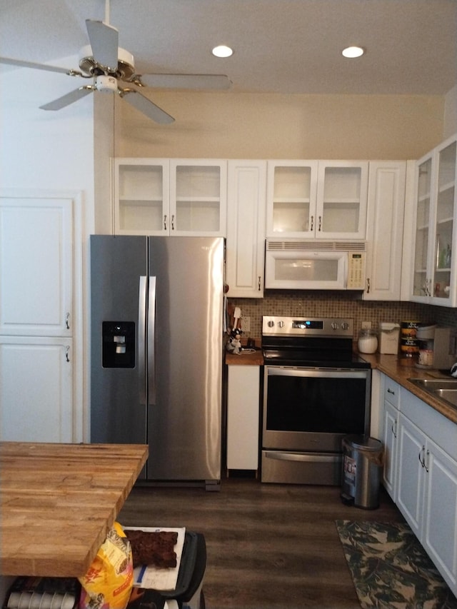 1047 NW Tuscany Dr, Port Saint Lucie, FL 34986 - kitchen with white cabinetry, dark countertops, backsplash, and appliances with stainless steel finishes