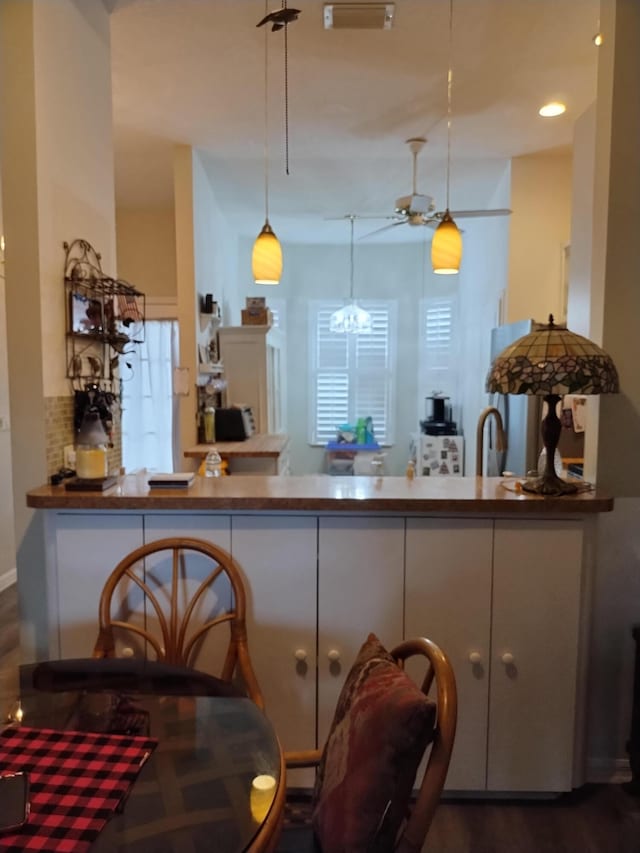 1047 NW Tuscany Dr, Port Saint Lucie, FL 34986 - kitchen featuring ceiling fan, decorative light fixtures, a peninsula, and tasteful backsplash