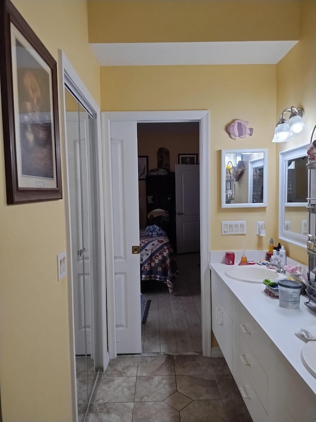 1047 NW Tuscany Dr, Port Saint Lucie, FL 34986 - ensuite bathroom with double vanity, ensuite bath, tile patterned flooring, and a sink