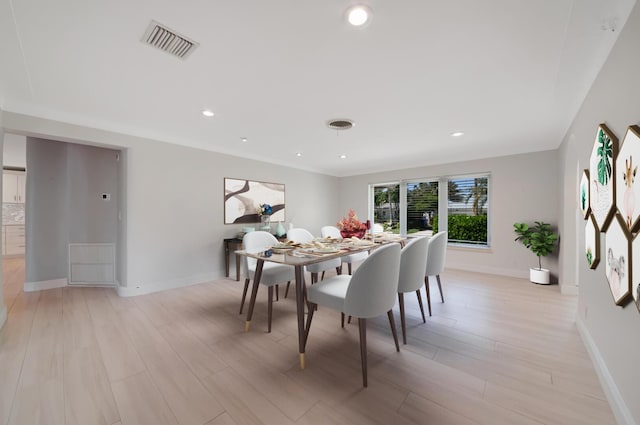 dining room with light wood-type flooring, baseboards, and recessed lighting
