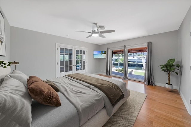 bedroom with access to exterior, light wood-style floors, baseboards, a ceiling fan, and french doors