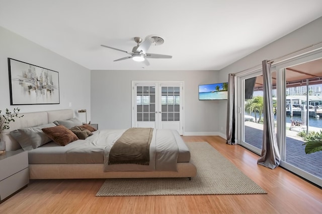 bedroom featuring access to exterior, light wood finished floors, french doors, baseboards, and a ceiling fan