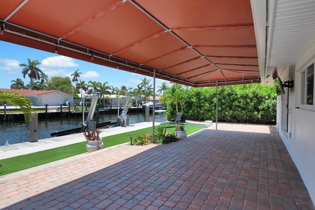 view of patio / terrace with a water view, boat lift, and a boat dock