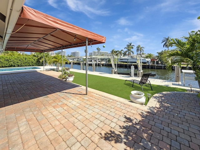view of patio with boat lift, a water view, a dock, and an outdoor pool