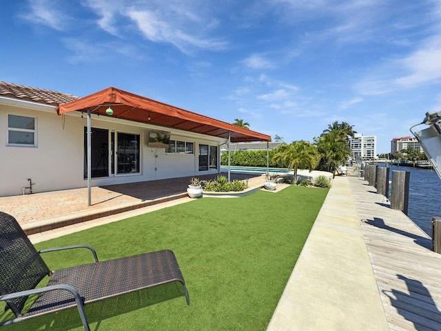 view of green lawn featuring a patio