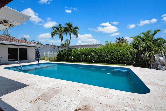 view of pool with a patio area and fence