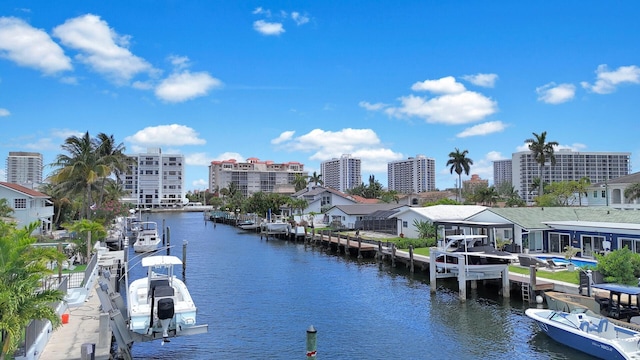 water view with a dock, nearby urban area, and boat lift