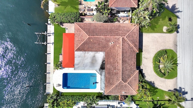 drone / aerial view of a pool and a large body of water