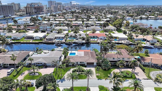 aerial view of property and surrounding area featuring nearby suburban area, a nearby body of water, and nearby urban area