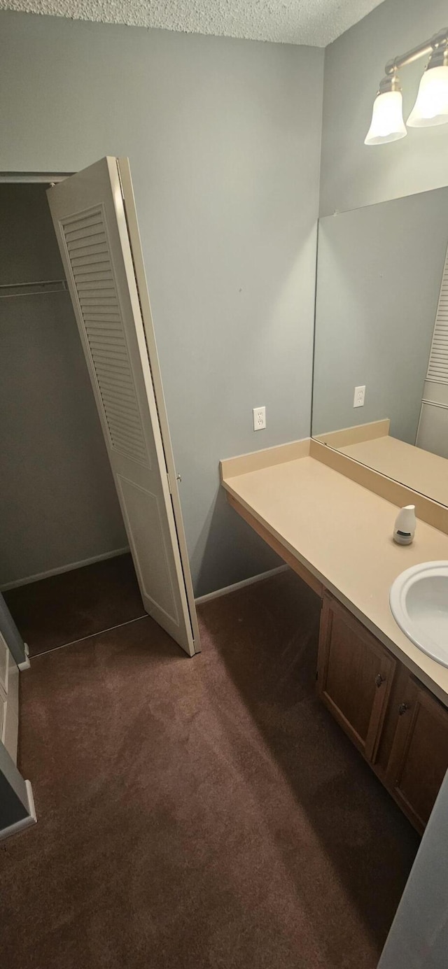 163 Pinto Palm Ct Unit 02, Royal Palm Beach, FL 33411 - bathroom featuring a closet, vanity, carpet flooring, and baseboards