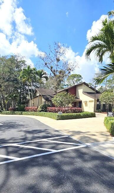 163 Pinto Palm Ct Unit 02, Royal Palm Beach, FL 33411 - view of front of home featuring uncovered parking and stucco siding