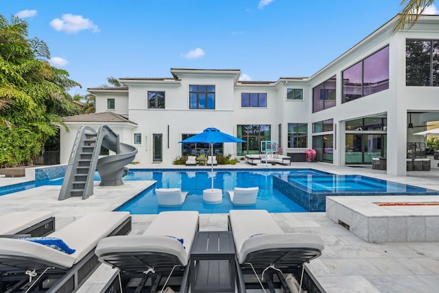 8388 Del Prado Dr, Delray Beach, FL 33446 - view of swimming pool featuring a patio, a pool with connected hot tub, outdoor dining area, and an outdoor living space