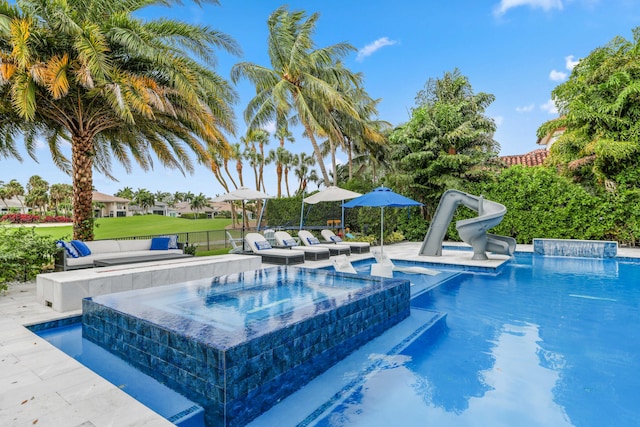 8388 Del Prado Dr, Delray Beach, FL 33446 - outdoor pool with a water slide, an in-ground hot tub, and outdoor lounge area