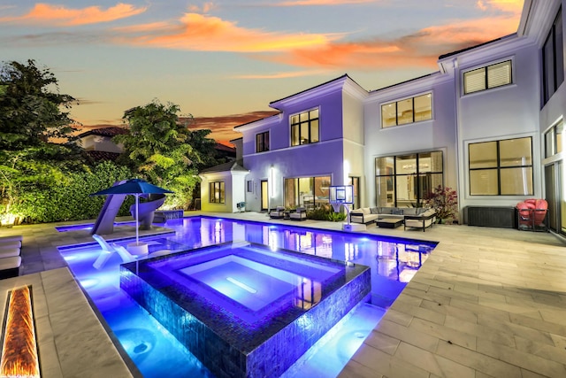8388 Del Prado Dr, Delray Beach, FL 33446 - back of property featuring an outdoor living space, a patio, stucco siding, and a pool with connected hot tub