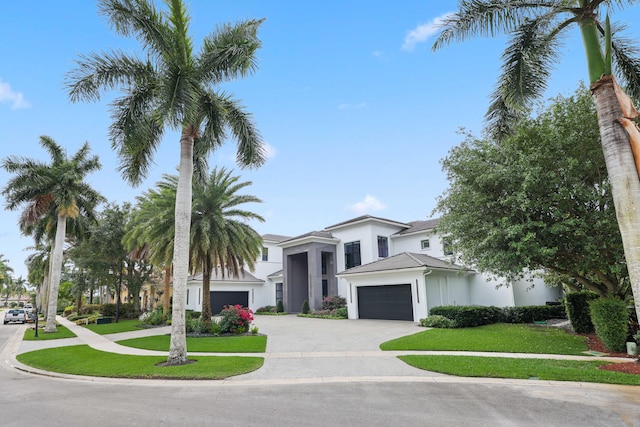 8388 Del Prado Dr, Delray Beach, FL 33446 - view of front facade featuring stucco siding, an attached garage, a front lawn, and driveway