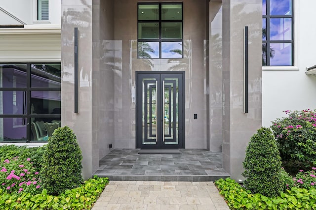 8388 Del Prado Dr, Delray Beach, FL 33446 - view of exterior entry featuring french doors and stucco siding