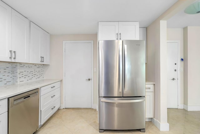kitchen with backsplash, light countertops, stainless steel appliances, and white cabinetry