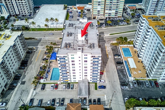 birds eye view of property with a water view and a city view