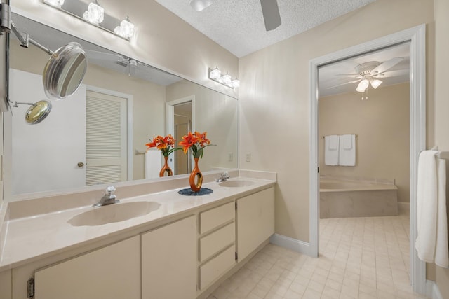 full bath with a textured ceiling, a sink, and a ceiling fan