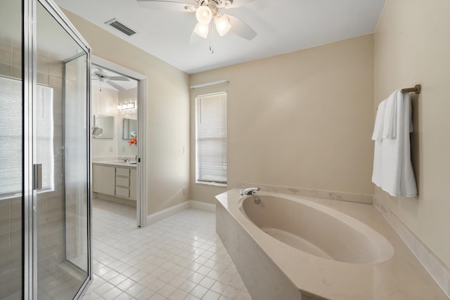 bathroom featuring a stall shower, vanity, a garden tub, visible vents, and ceiling fan