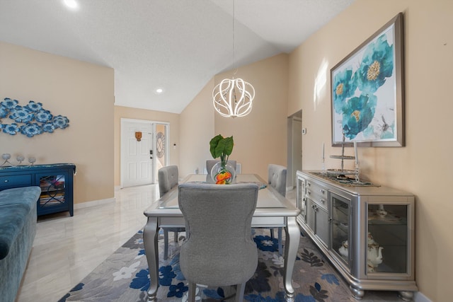 dining room featuring baseboards and lofted ceiling