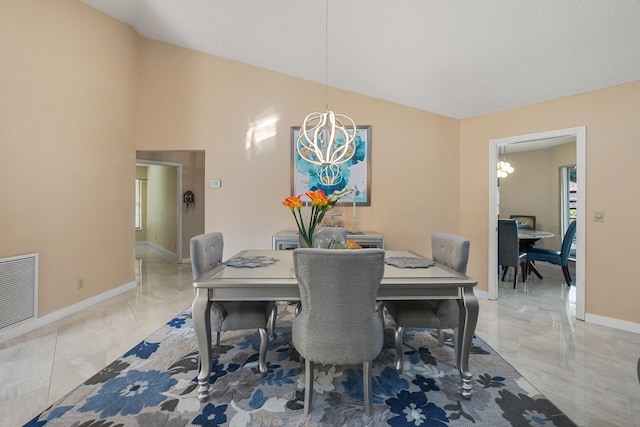 dining room featuring baseboards, visible vents, lofted ceiling, and an inviting chandelier