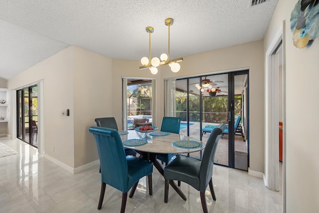 dining room with baseboards, a chandelier, and a textured ceiling