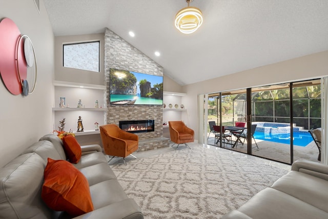 living room featuring a textured ceiling, a large fireplace, high vaulted ceiling, and built in shelves
