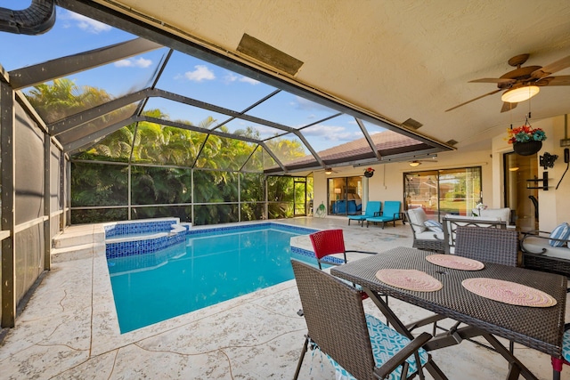 view of pool featuring ceiling fan, a pool with connected hot tub, an outdoor living space, and a patio