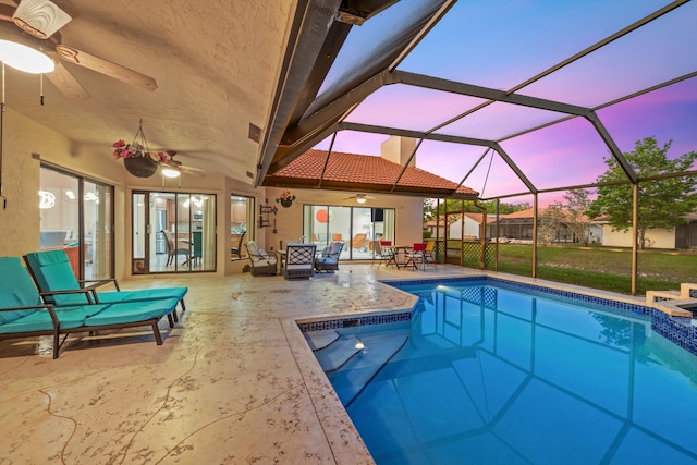 outdoor pool with ceiling fan, a lanai, and a patio area