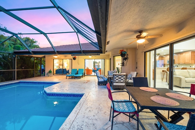 outdoor pool featuring outdoor lounge area, a lanai, and a patio area