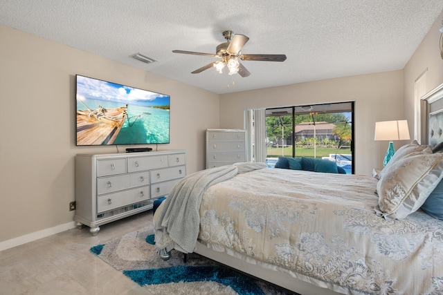 bedroom featuring baseboards, access to outside, a textured ceiling, ceiling fan, and visible vents