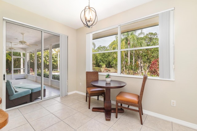 dining space with light tile patterned flooring, a wealth of natural light, and baseboards