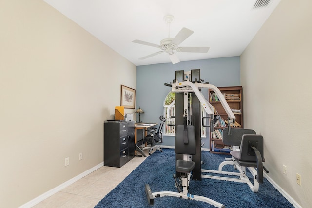 exercise room featuring baseboards, ceiling fan, visible vents, and tile patterned flooring