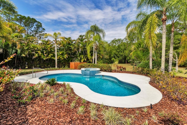 view of pool with a pool with connected hot tub and fence