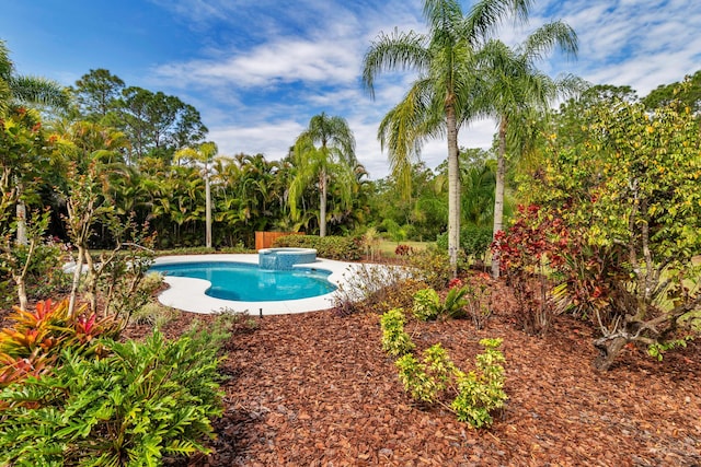 view of pool with a pool with connected hot tub