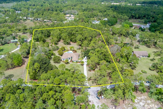bird's eye view featuring a wooded view