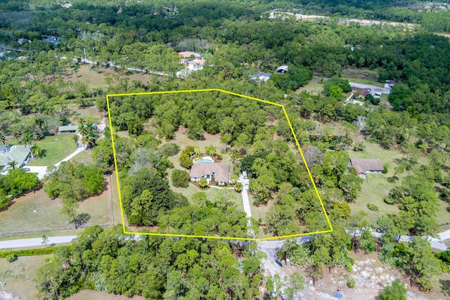 birds eye view of property with a view of trees